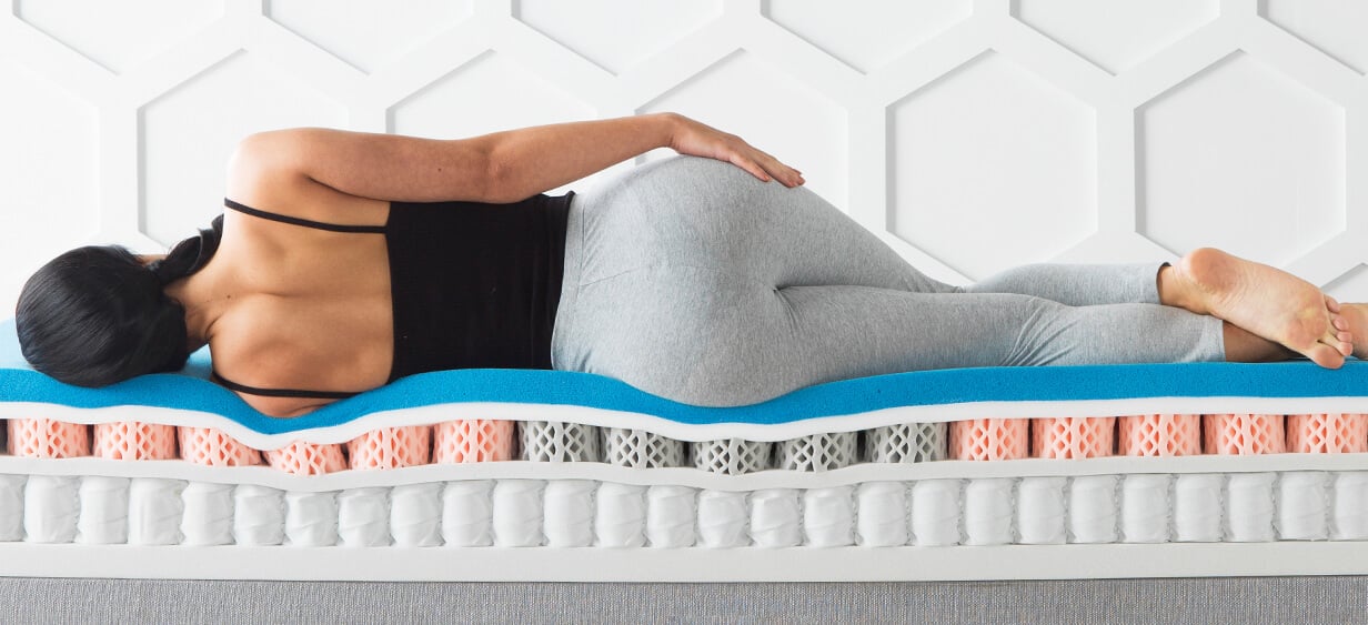 Side sleeper using best pillow top mattress for back pain and hip pressure relief